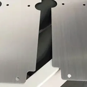 Metal part before and after deburring showing clean edge rounding